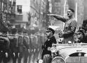 Hitler salutes his men.